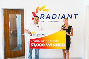 An image of Live Oak Branch Manager Carissa Adams presenting our $1,000 award to Suwannee Valley Unsolved, our June Charity of the Month.